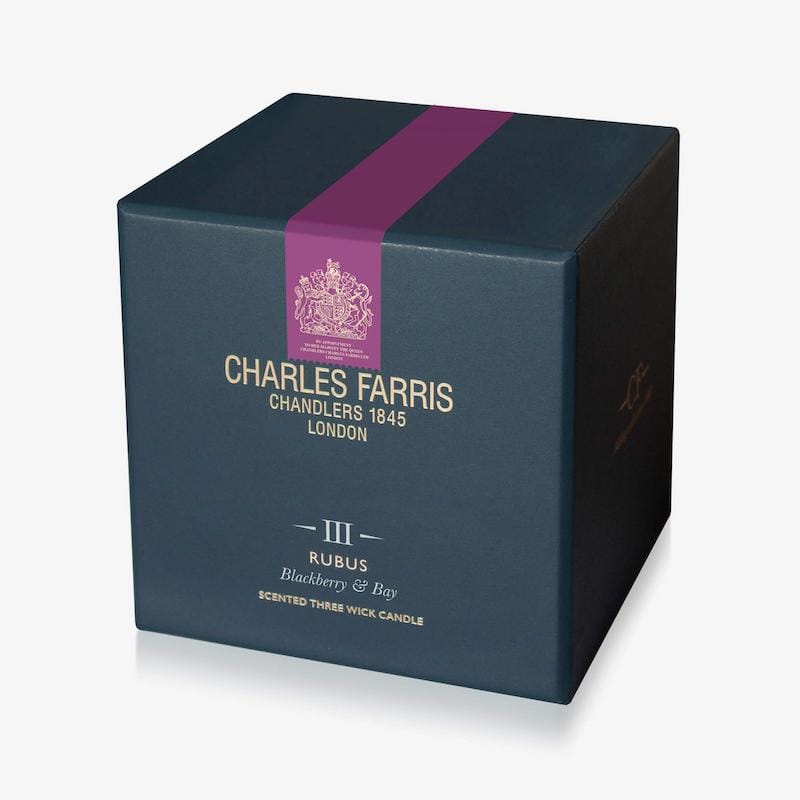 Blue candle box with purple ribbon and 'Charles Farris' branding on a white background