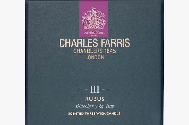 Blue candle box with 'Charles Farris' branding on a white background