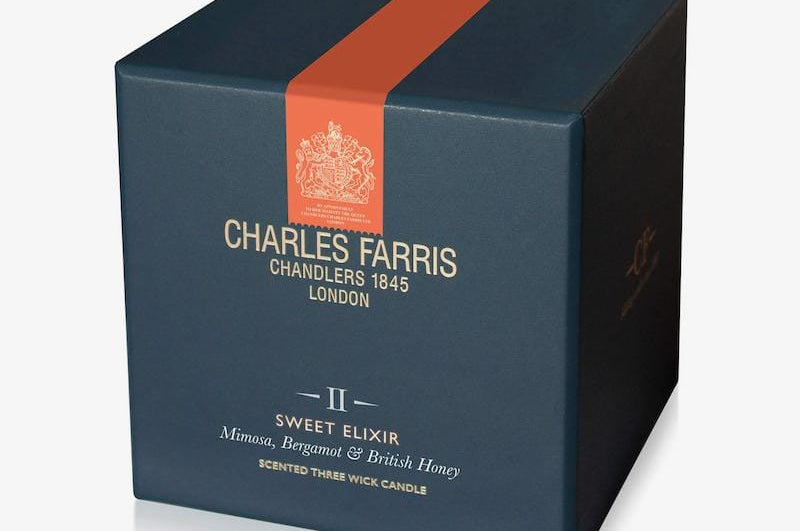 Blue candle box with orange stripe featuring Charles Farris branding on a white background