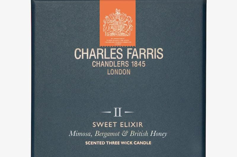 Blue candle box with 'Charles Farris' branding on a white background