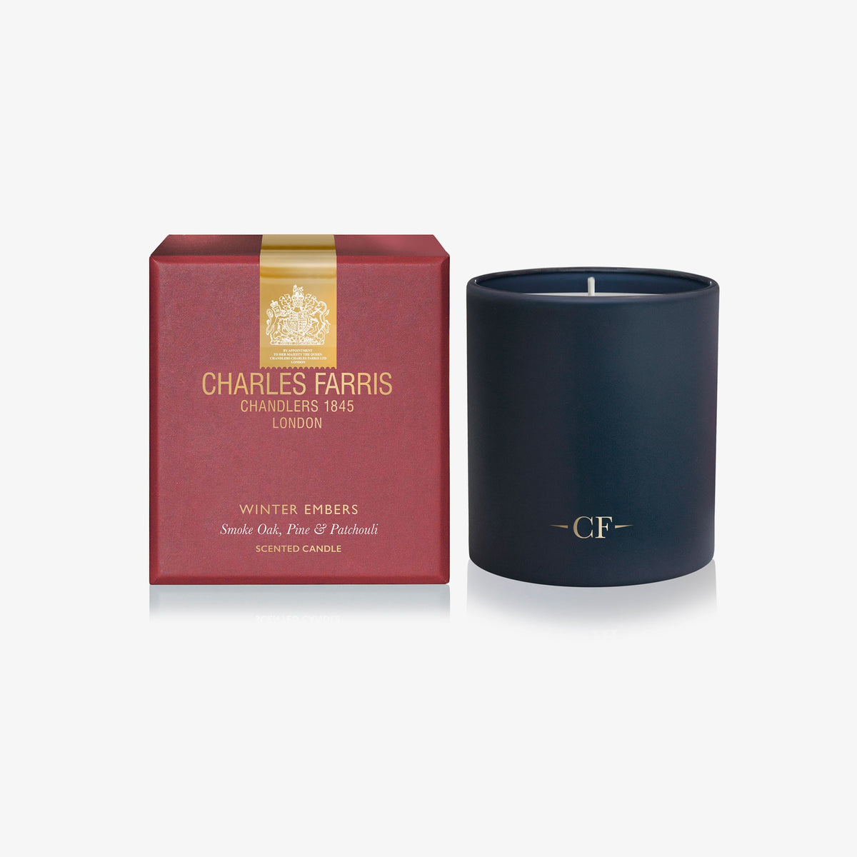 Charles Farris Winter Embers single wick scented candle, lit, in smoked oak, pine and patchouli