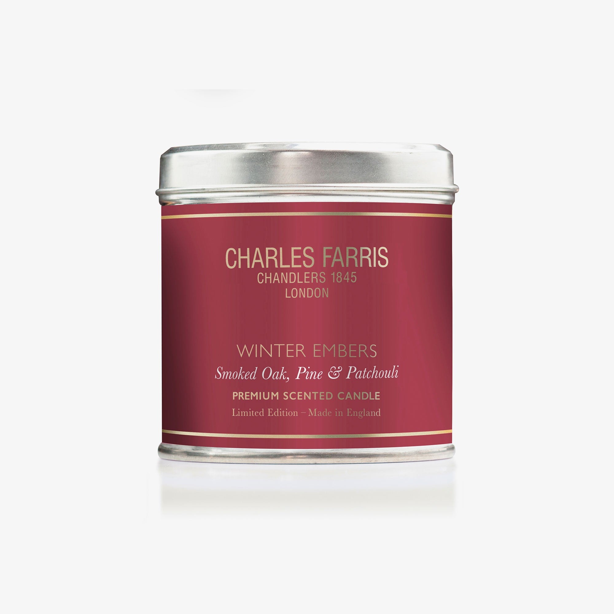 Charles Farris Winter Embers tin candle, front view in smoked oak, pine and patchouli
