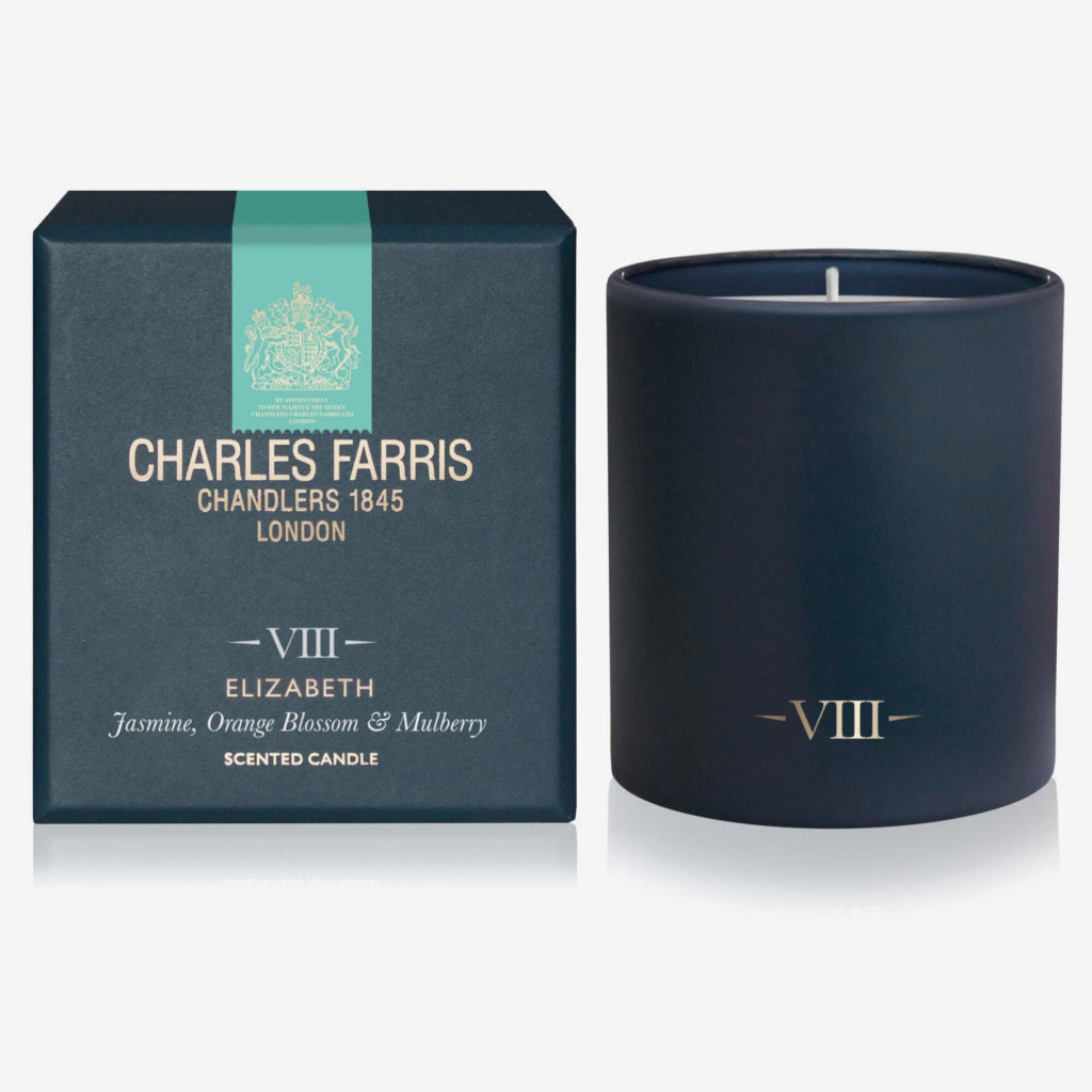 Dark blue candle with 'Charles Farris' packaging on a white background