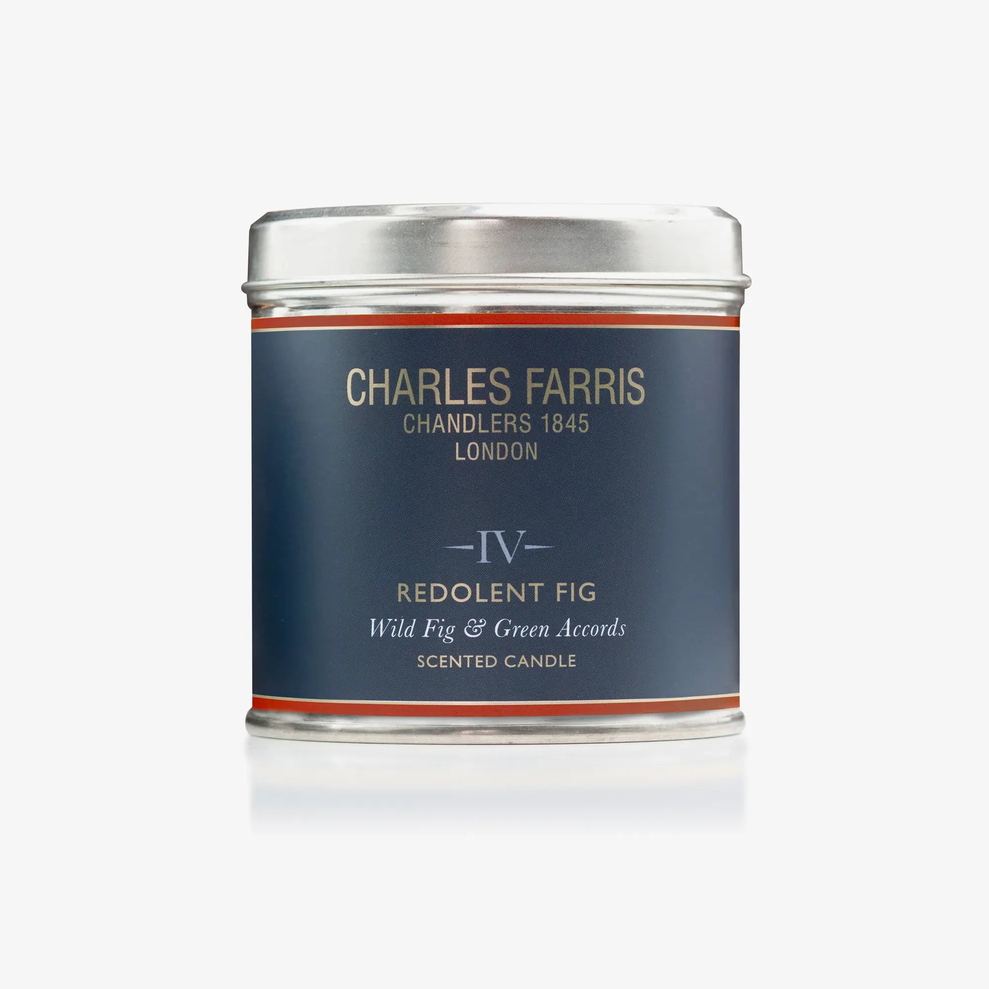 Scented candle tin labeled 'IV Redolent Fig' by Charles Farris on a white background