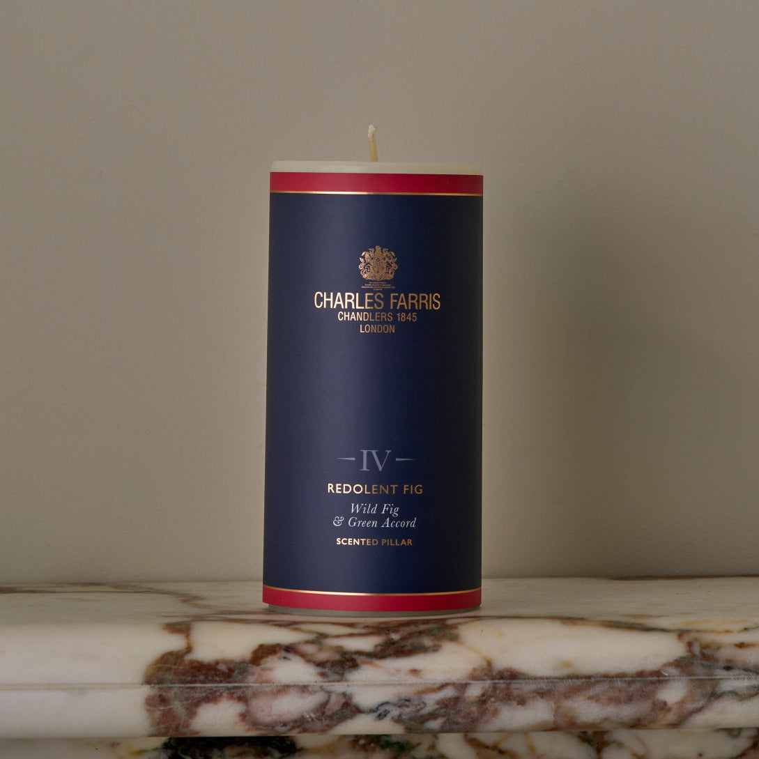 Candle with a blue and red label on a marble surface