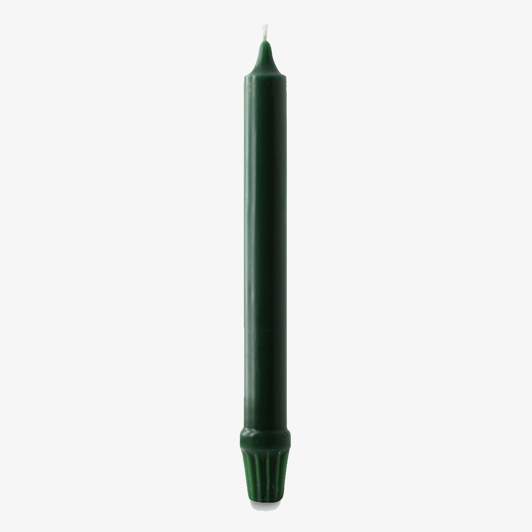 Green candle on a white background