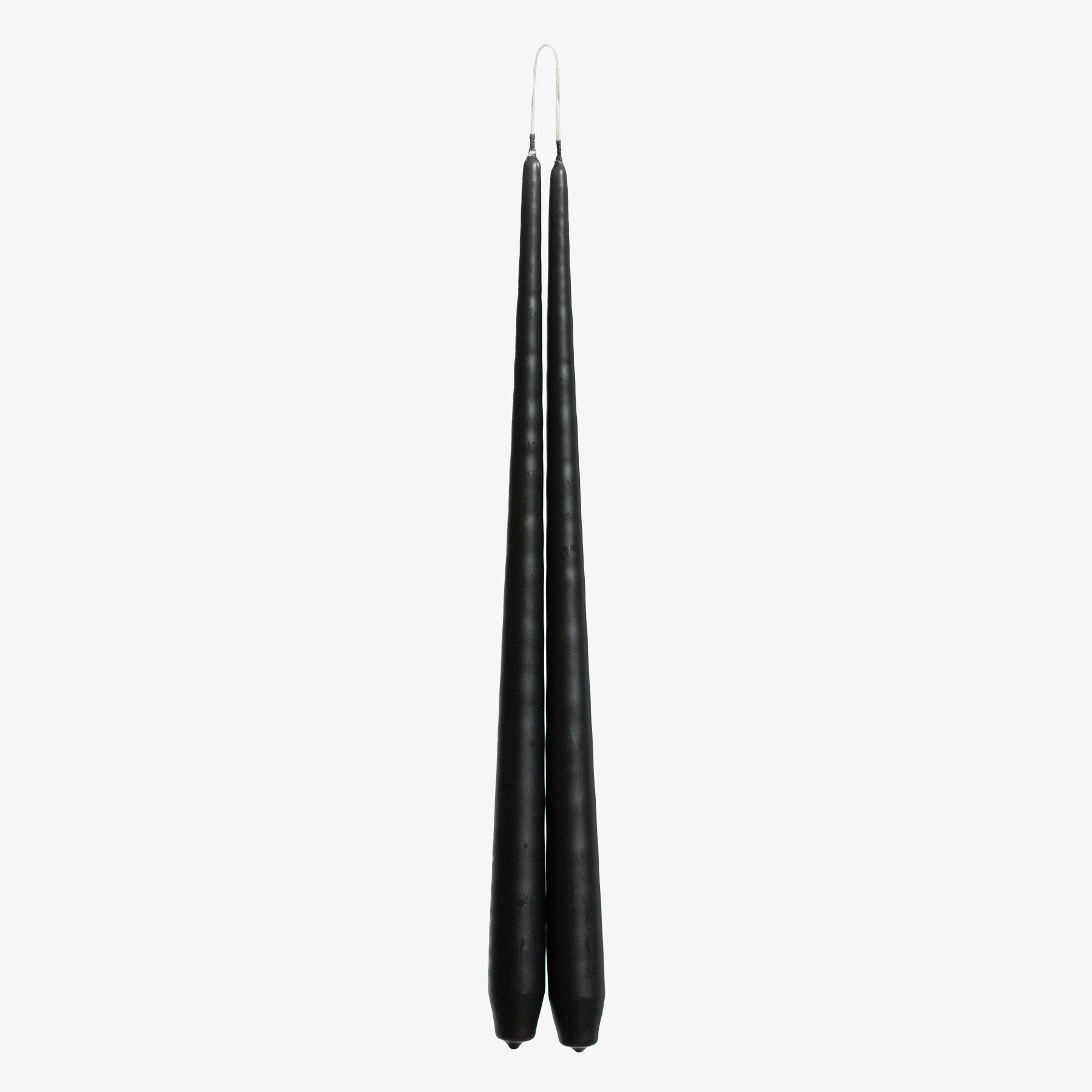 Two black candles on a white background