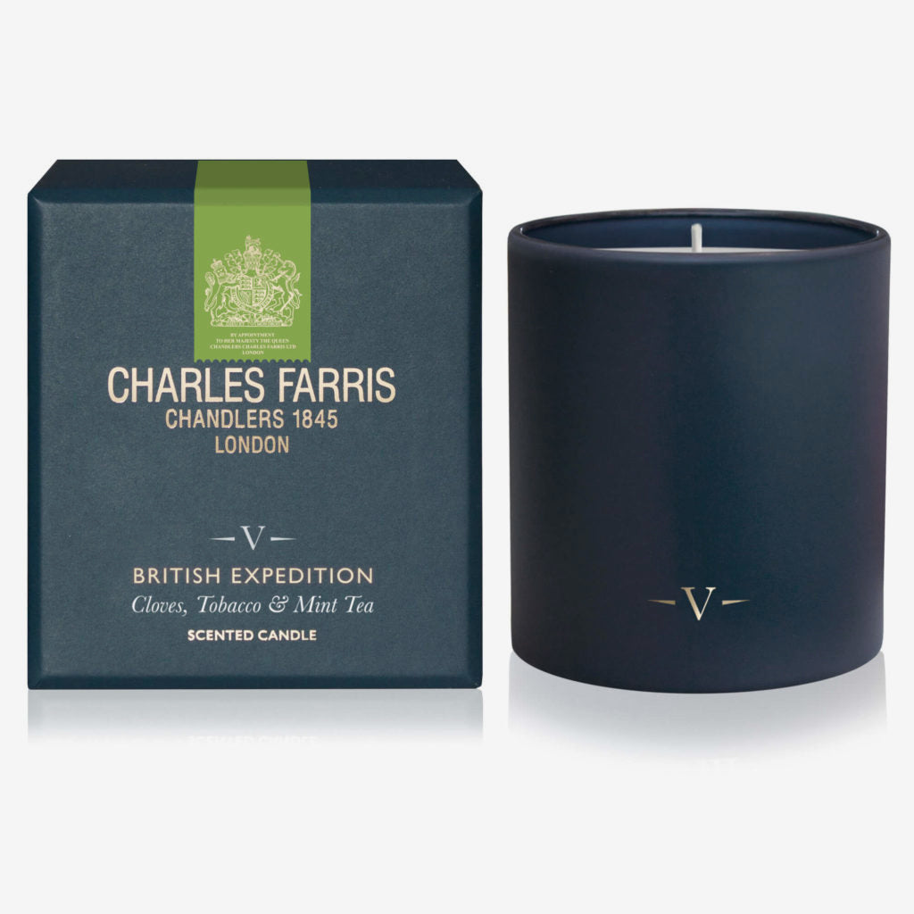 Navy blue candle with 'Charles Farris' packaging on a white background