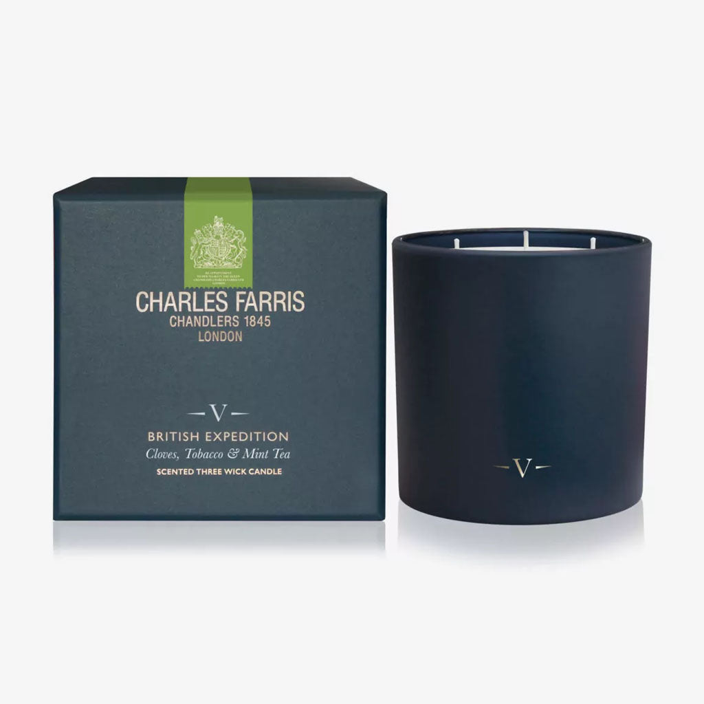 Dark blue candle with 'Charles Farris' packaging on a white background