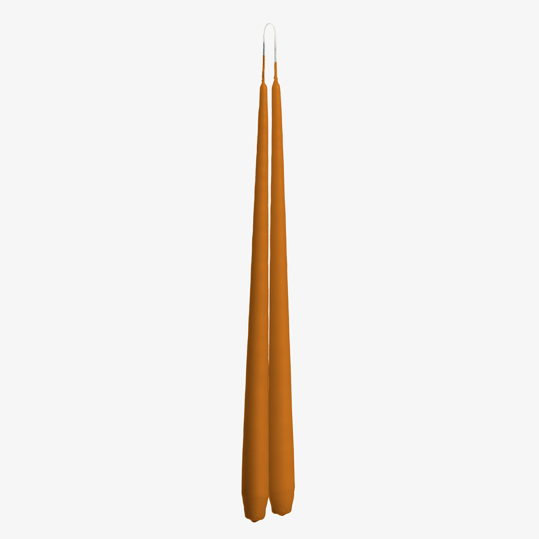 Two tall, thin, orange candles on a white background