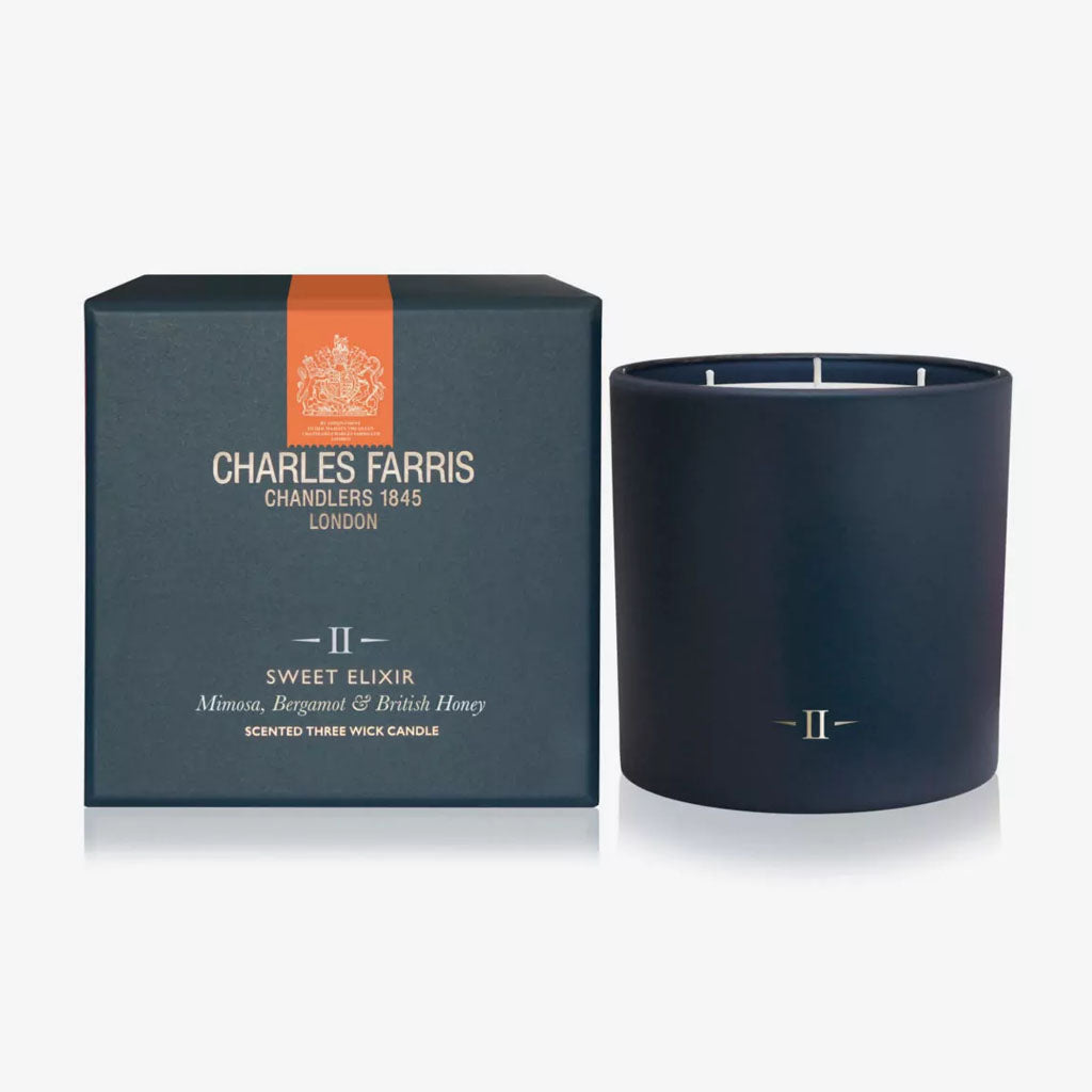 Dark blue candle with 'Charles Farris' packaging on a white background