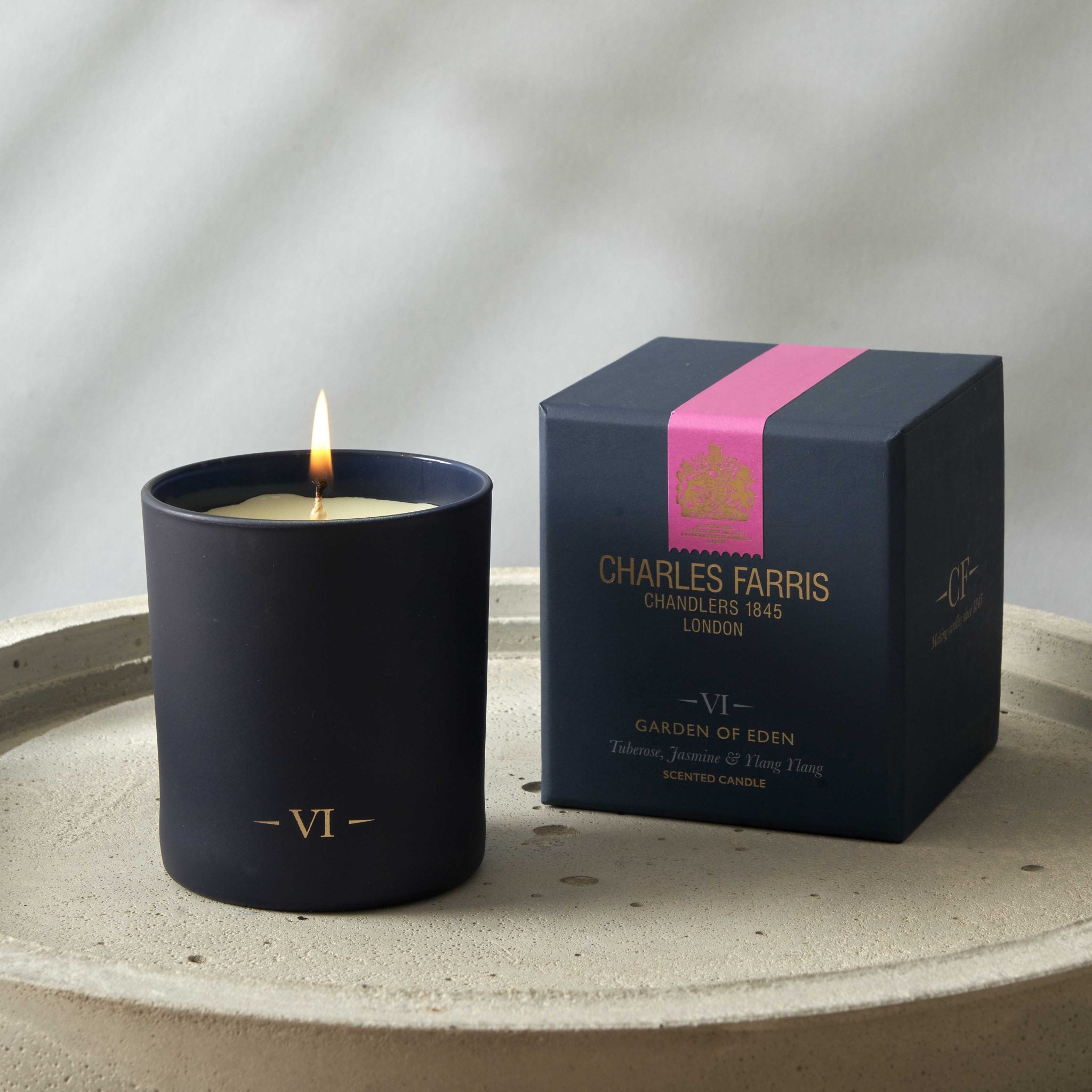 Candle and its packaging with 'Charles Farris' branding on a neutral background