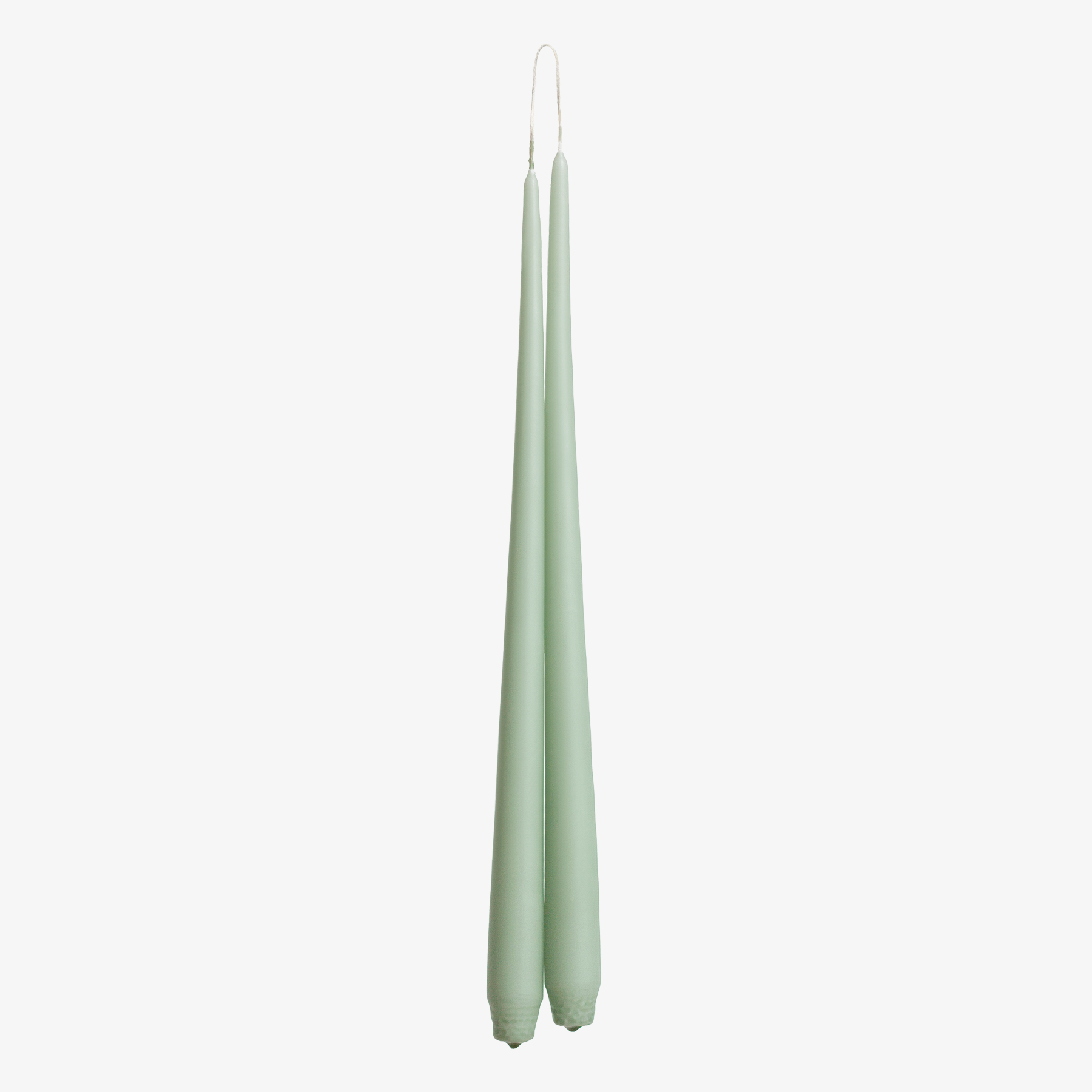 Two green candles on a white background