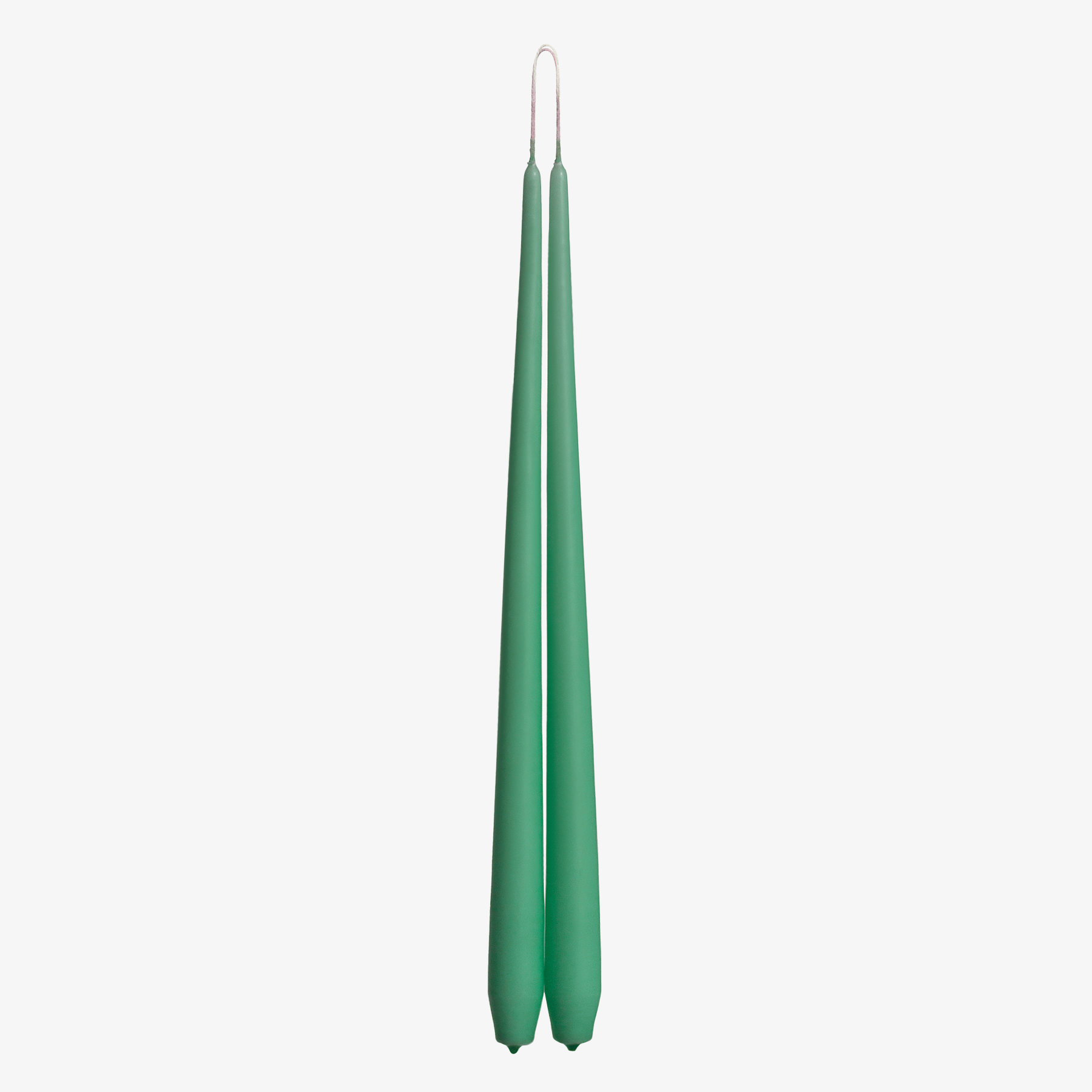 Two green candles on a white background