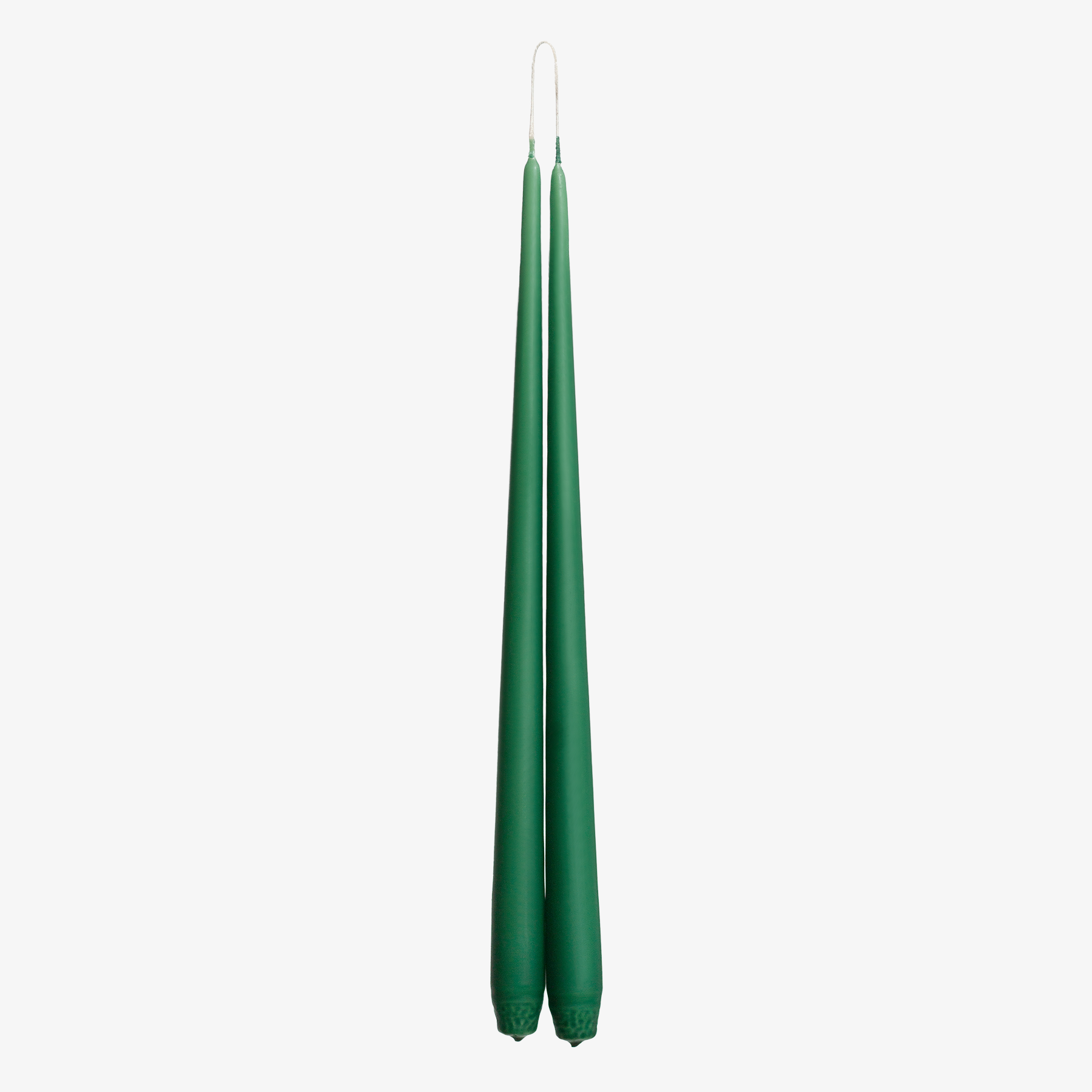 Two green candles on a white background