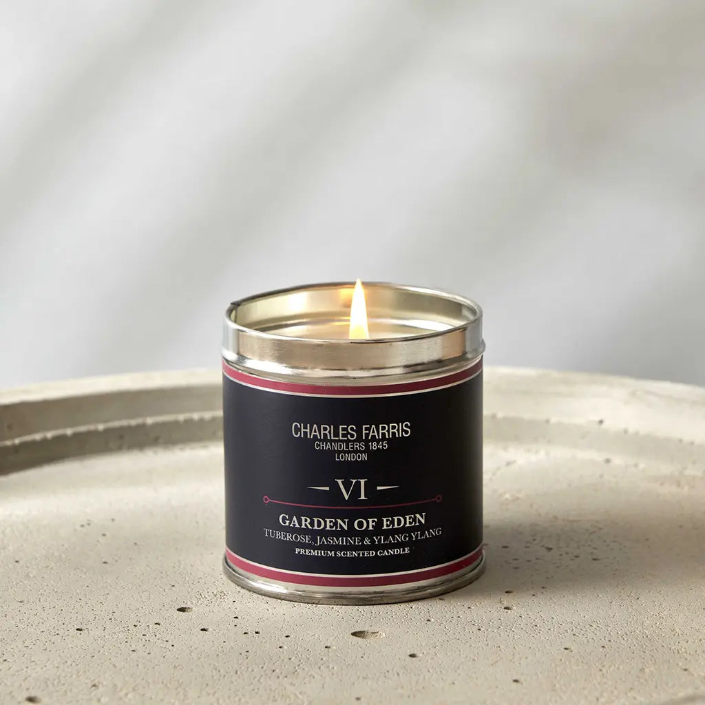 Garden of Eden tin candle by Charles Farris London, tuberose, jasmine & ylang ylang on a stone surface