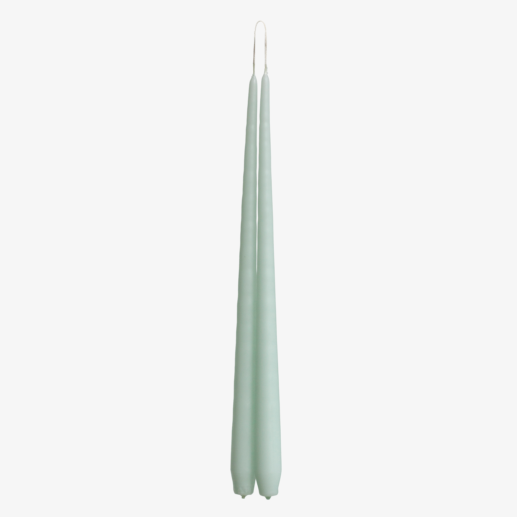 Two light green candles on a white background