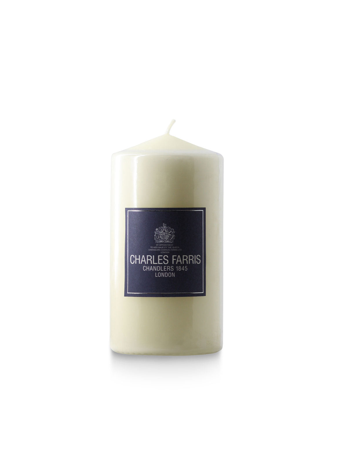 White candle with a 'Charles Farris' label on a white background