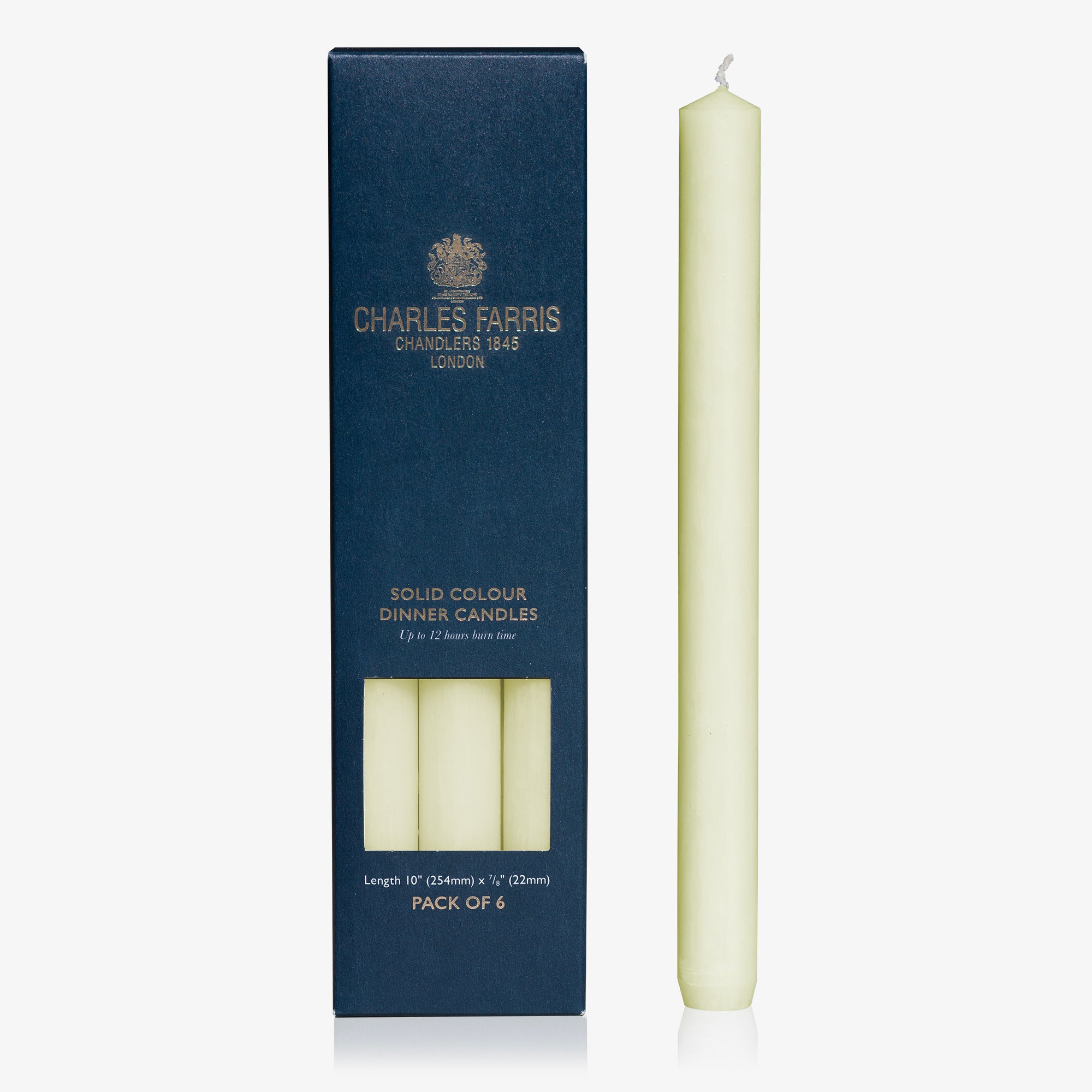 Ivory dinner candle next to its packaging with 'Charles Farris' branding on a white background