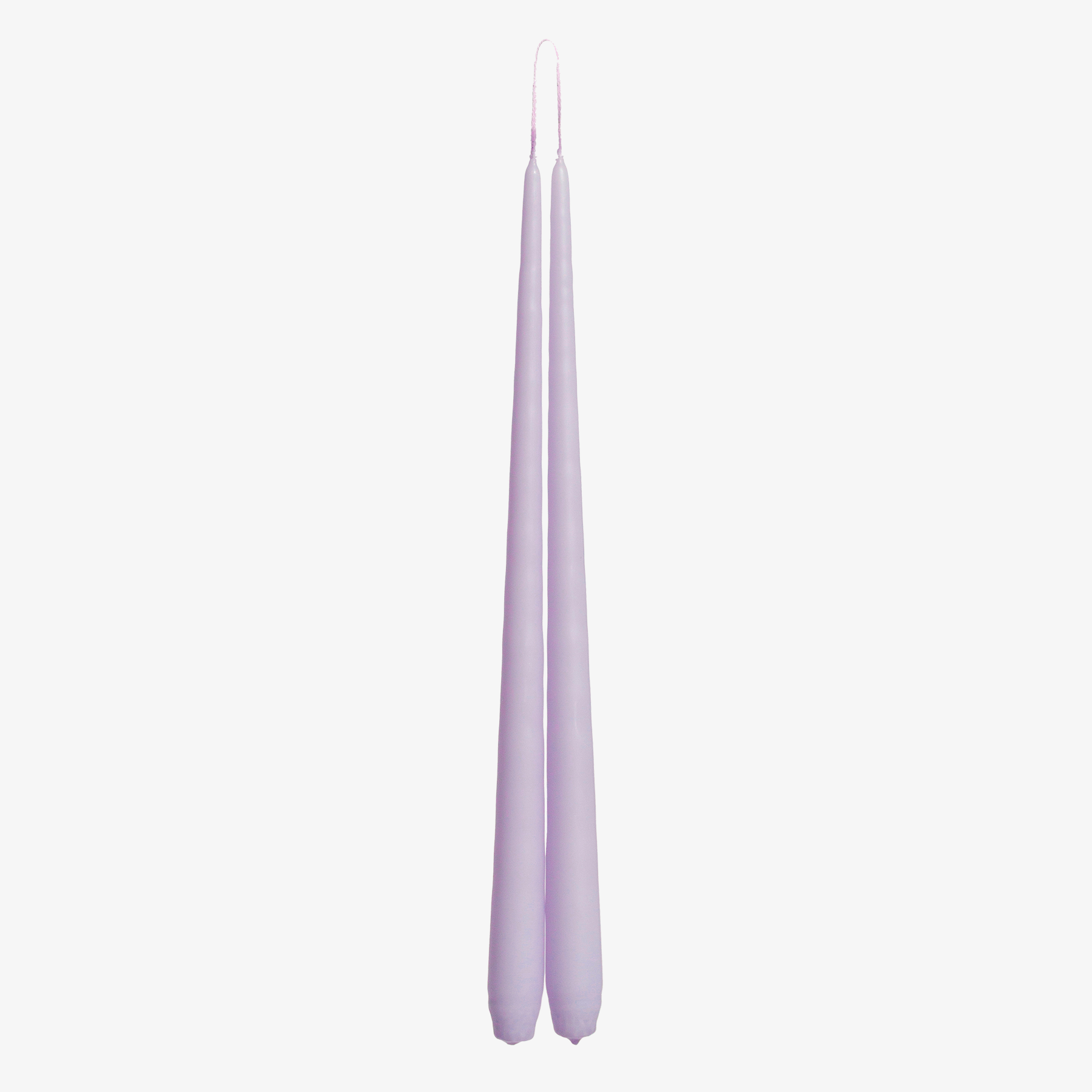 Two lavender candles on a white background