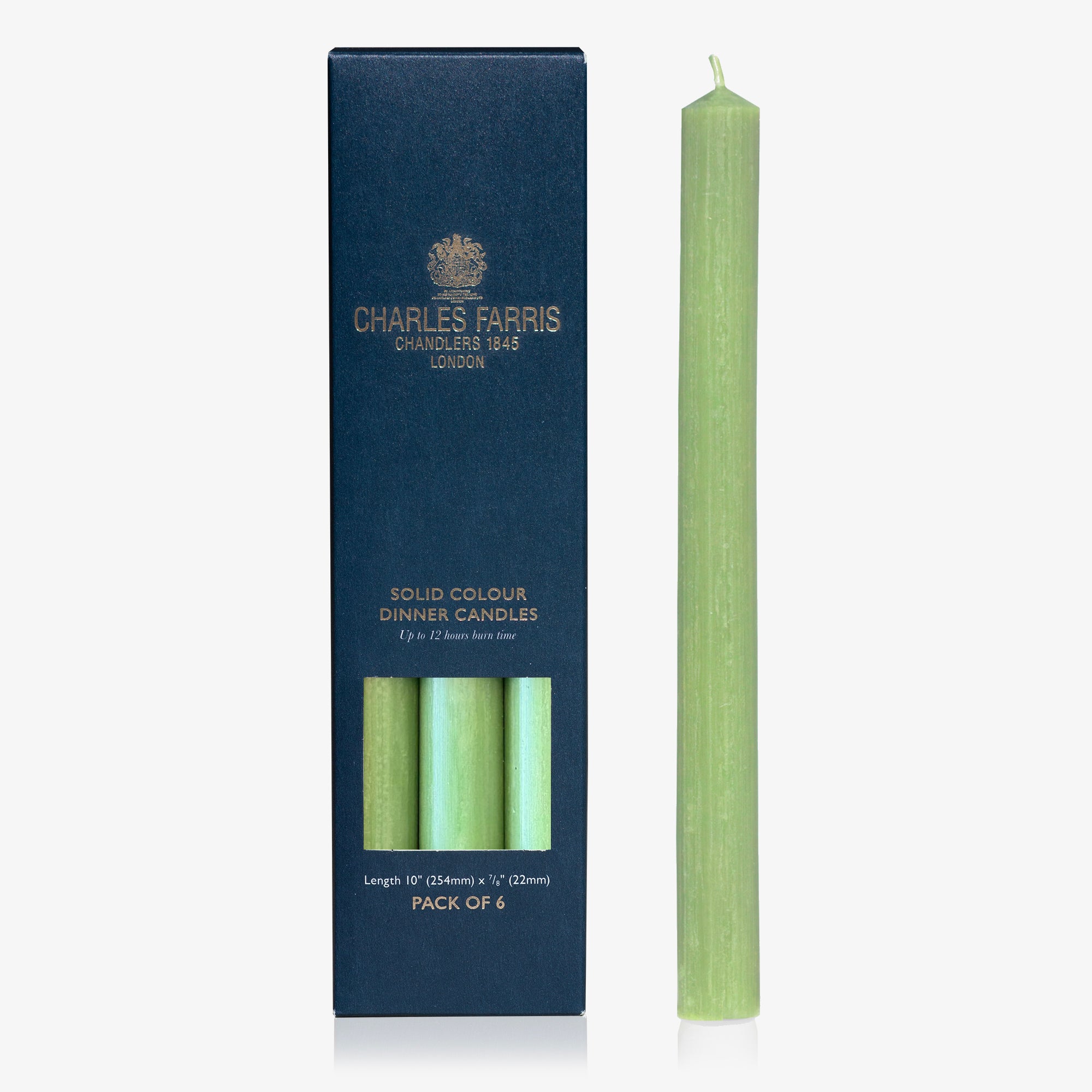 Green dinner candle with packaging displaying 'Charles Farris' branding on a white background