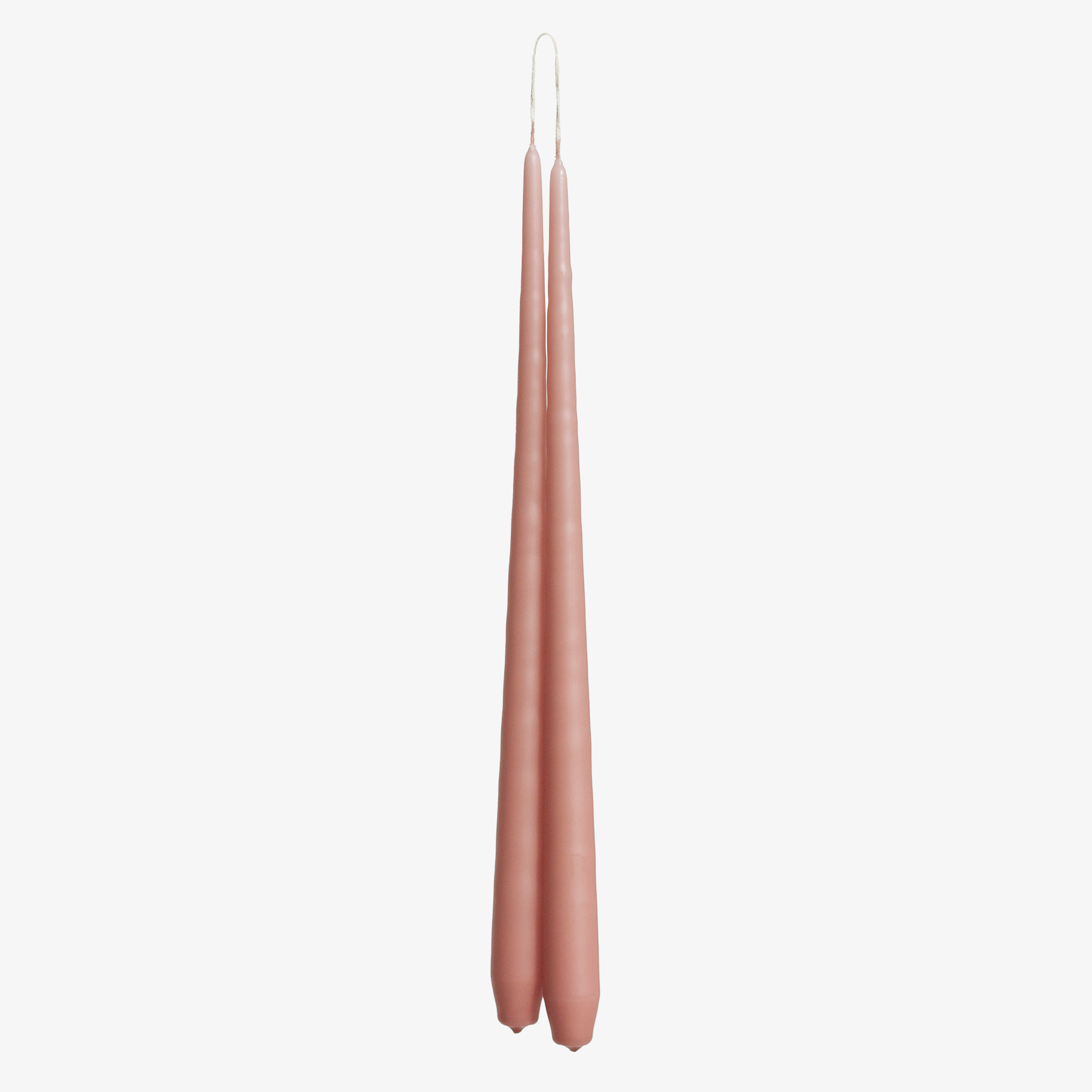 Two tall, thin, rose pink candles on a white background