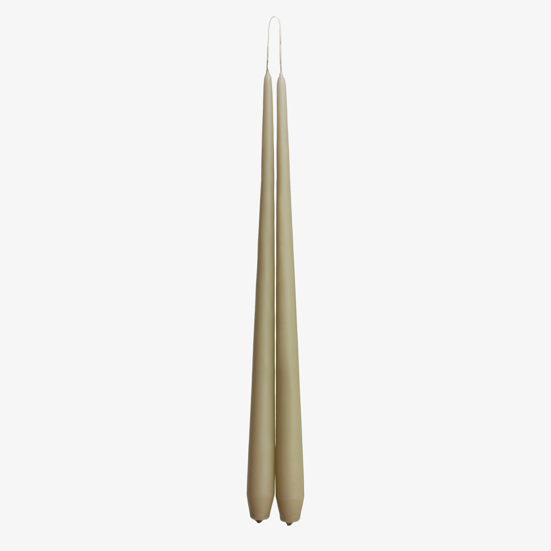 Two beige candles on a white background