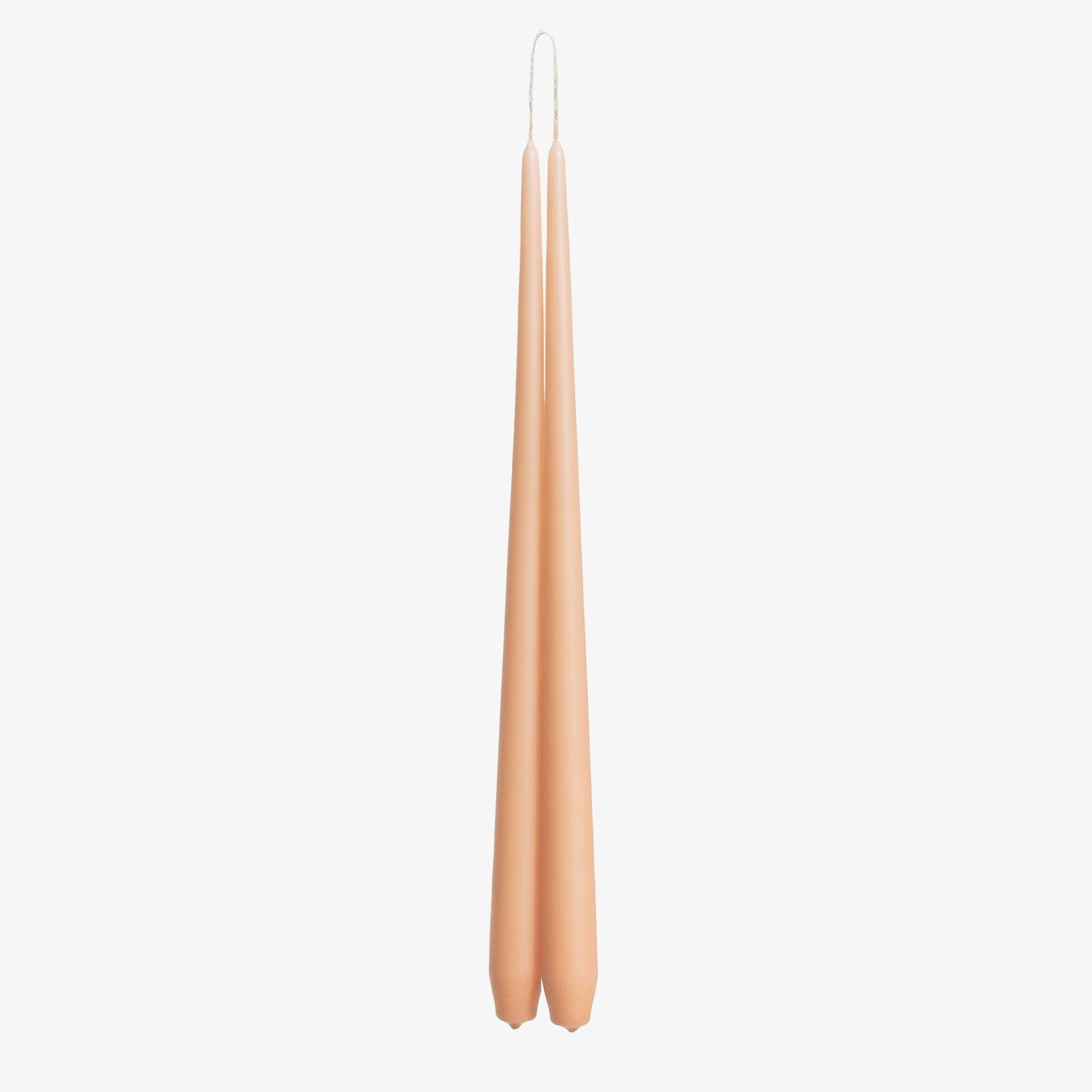Two rose gold candles on a white background