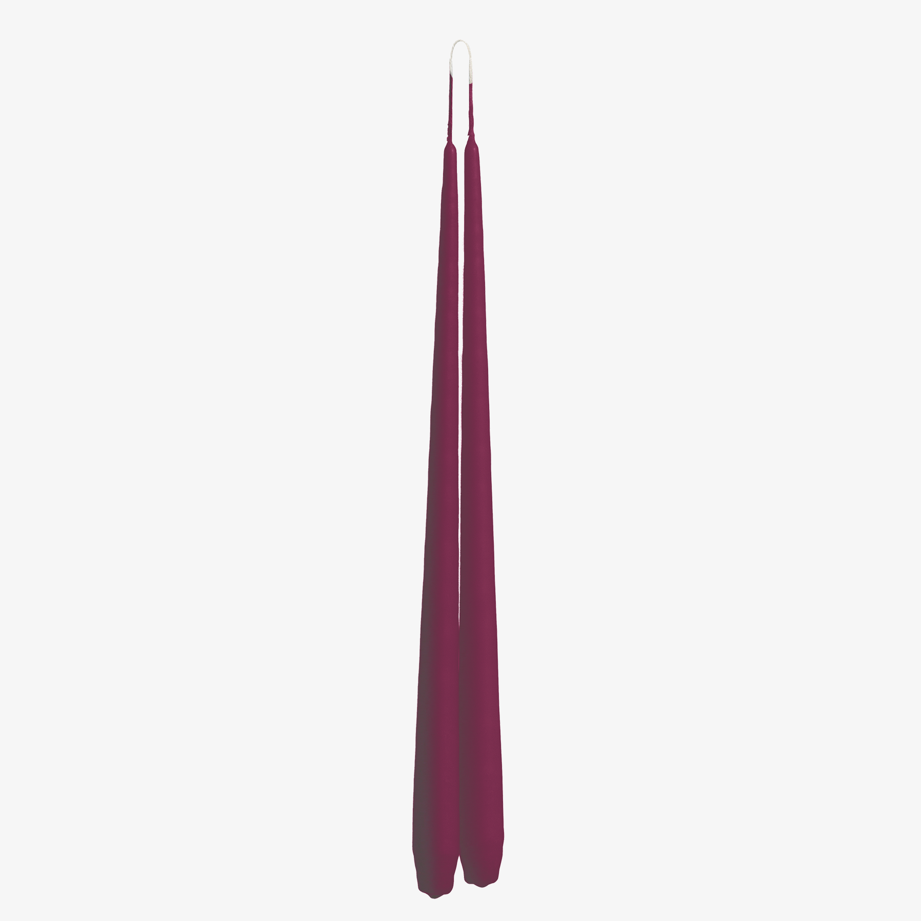 Two tall, thin, purple candles on a white background