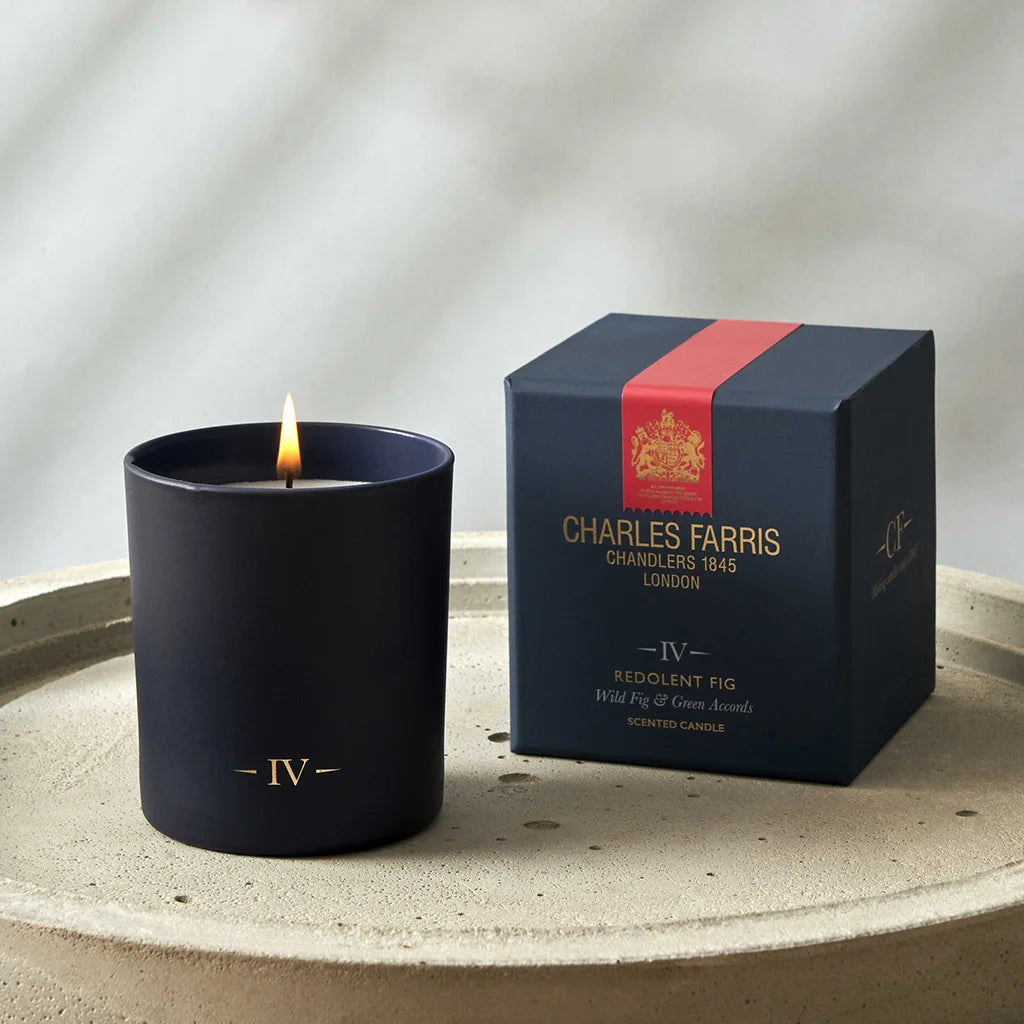 Charles Farris candle and packaging on a textured surface with a neutral background