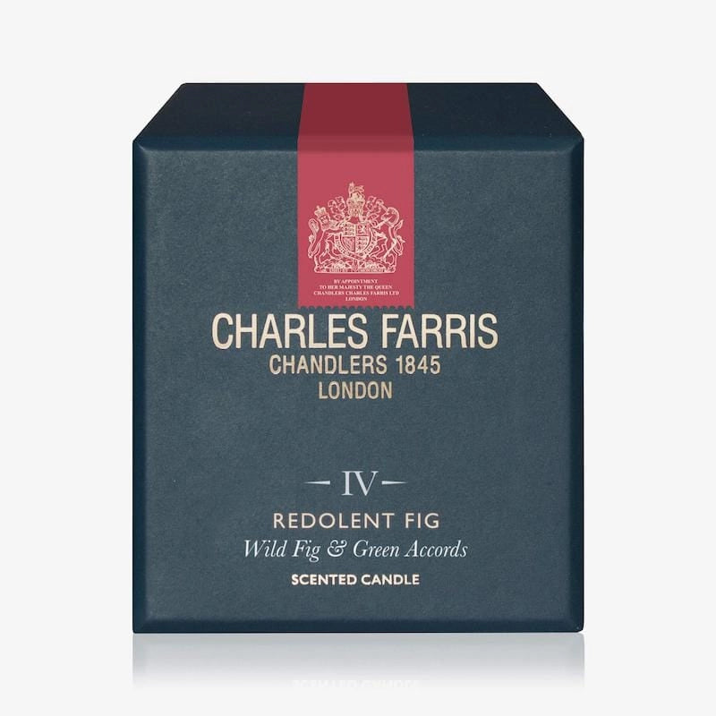 Blue box of Charles Farris scented candle with red ribbon on a white background