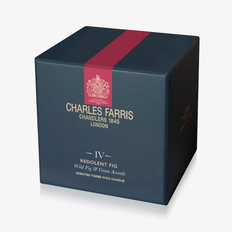 Dark blue candle box with red ribbon featuring Charles Farris branding on a white background