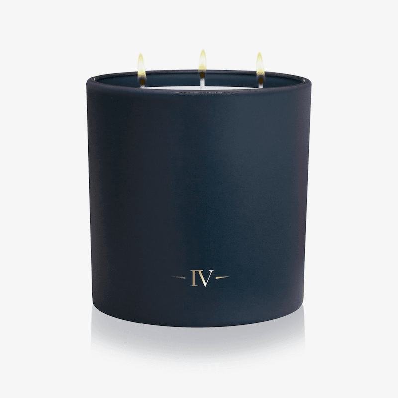 Navy blue candle with 'IV' logo on a white background