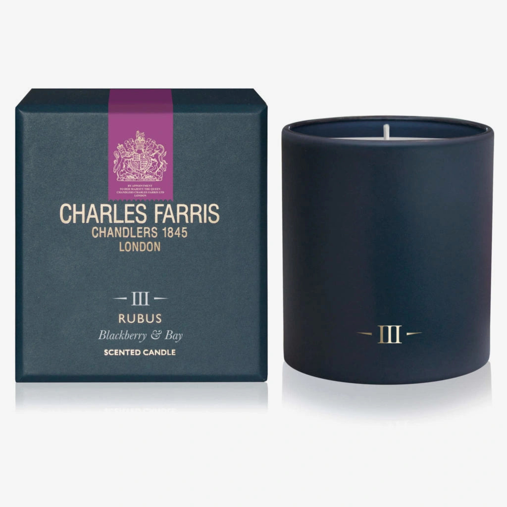 Navy blue candle with 'Charles Farris' packaging on a white background