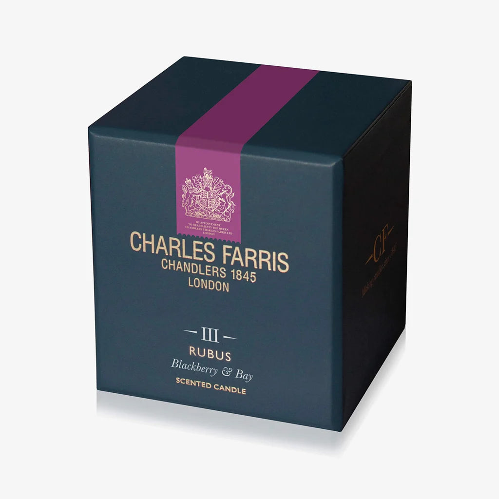Dark blue candle box with purple stripe featuring Charles Farris branding on a light gray background