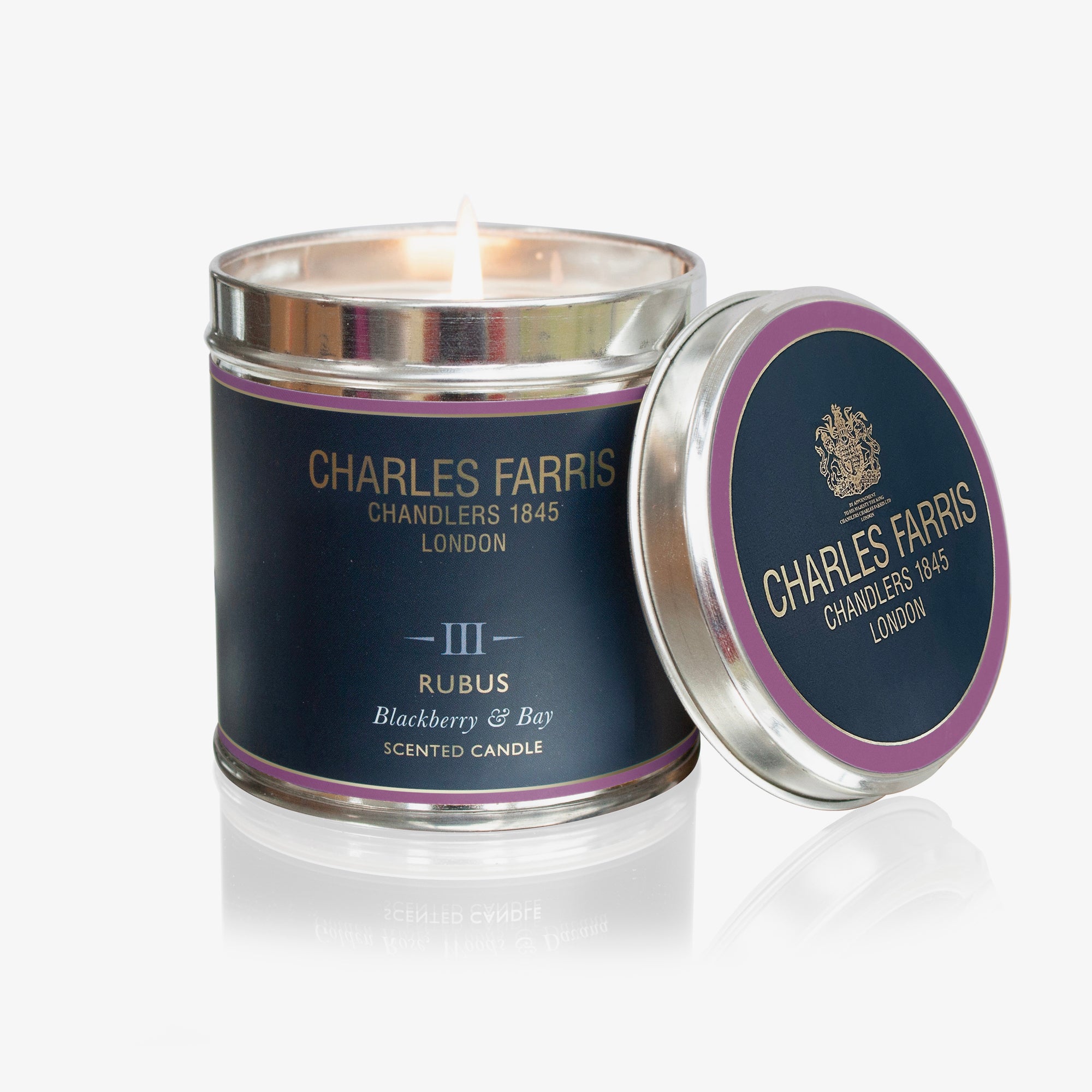 Charles Farris Rubus candle with a visible flame on a white background