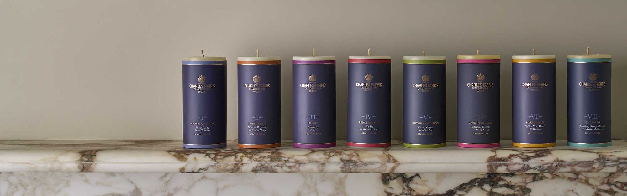 A row of Charles Farris scented pillar candles. 