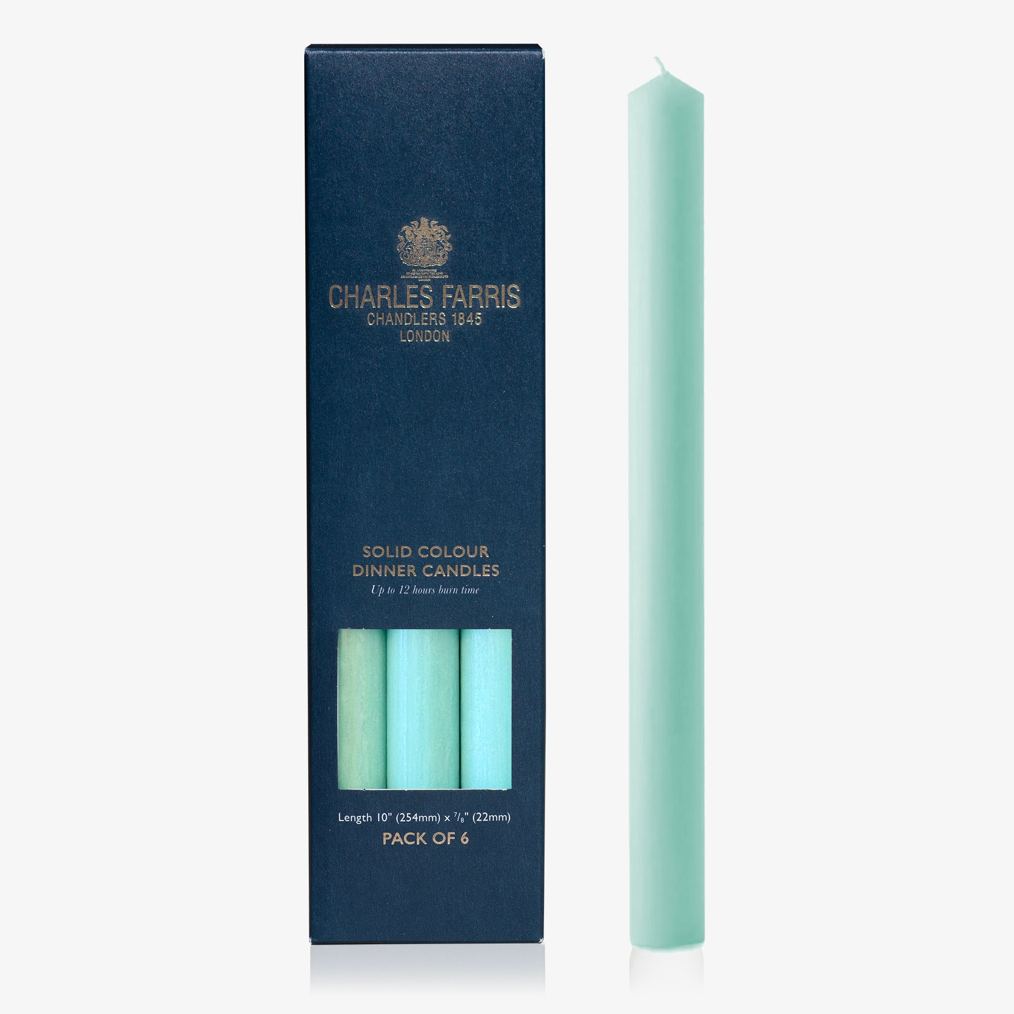 Mint green candle next to its packaging with 'Charles Farris' branding on a white background