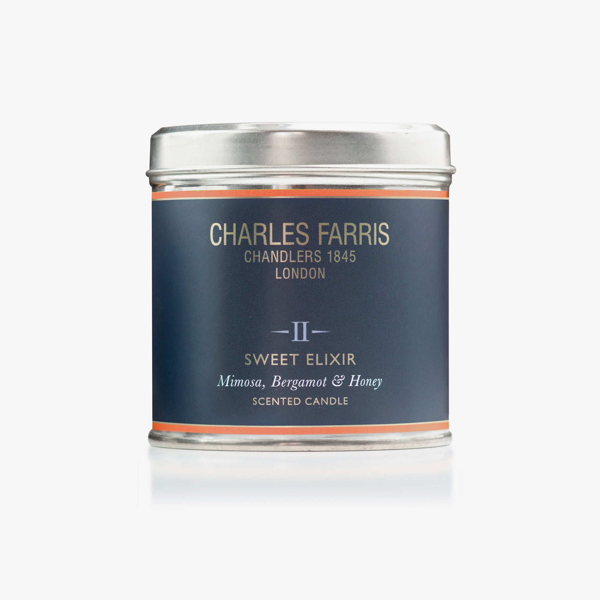 Sweet Elixir scented candle tin labeled 'Charles Farris' on a white background