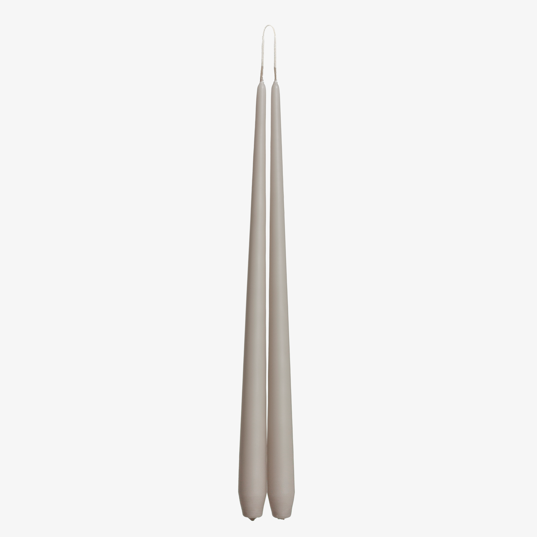 Two grayish brown candles on a white background