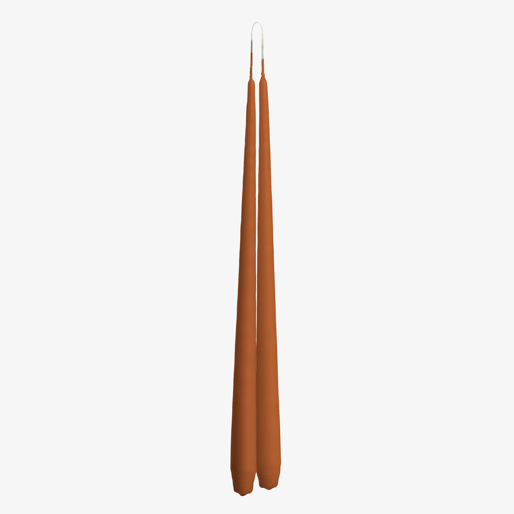 Two tall, thin, orange candles on a white background