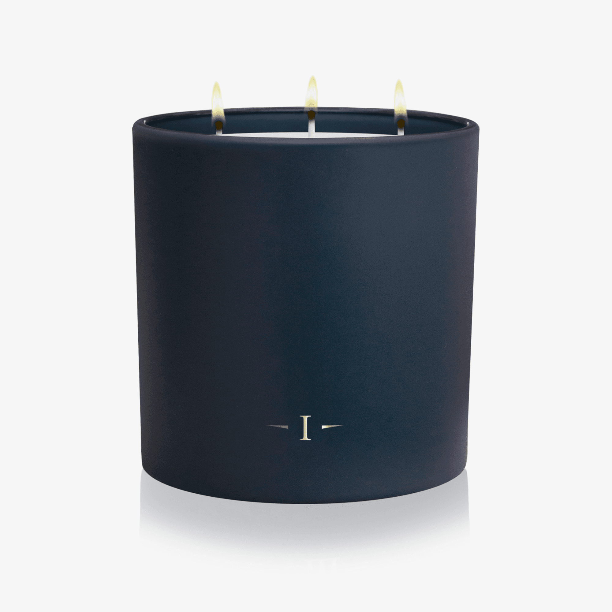 Navy blue candle with three wicks on a white background