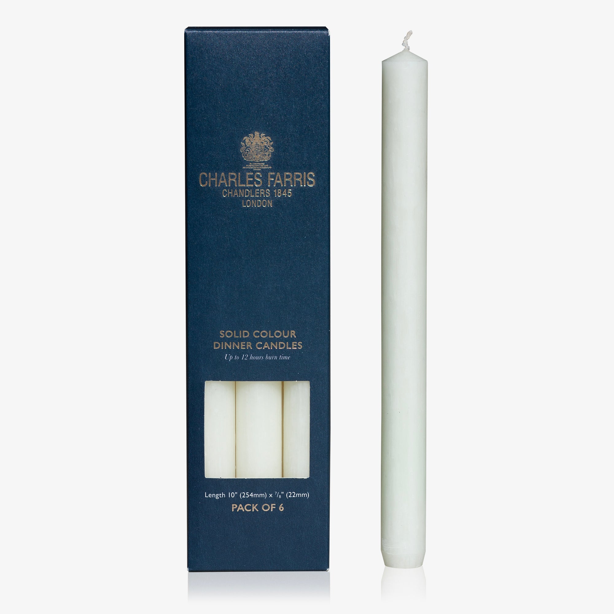White candle next to its packaging box with 'Charles Farris' branding on a white background