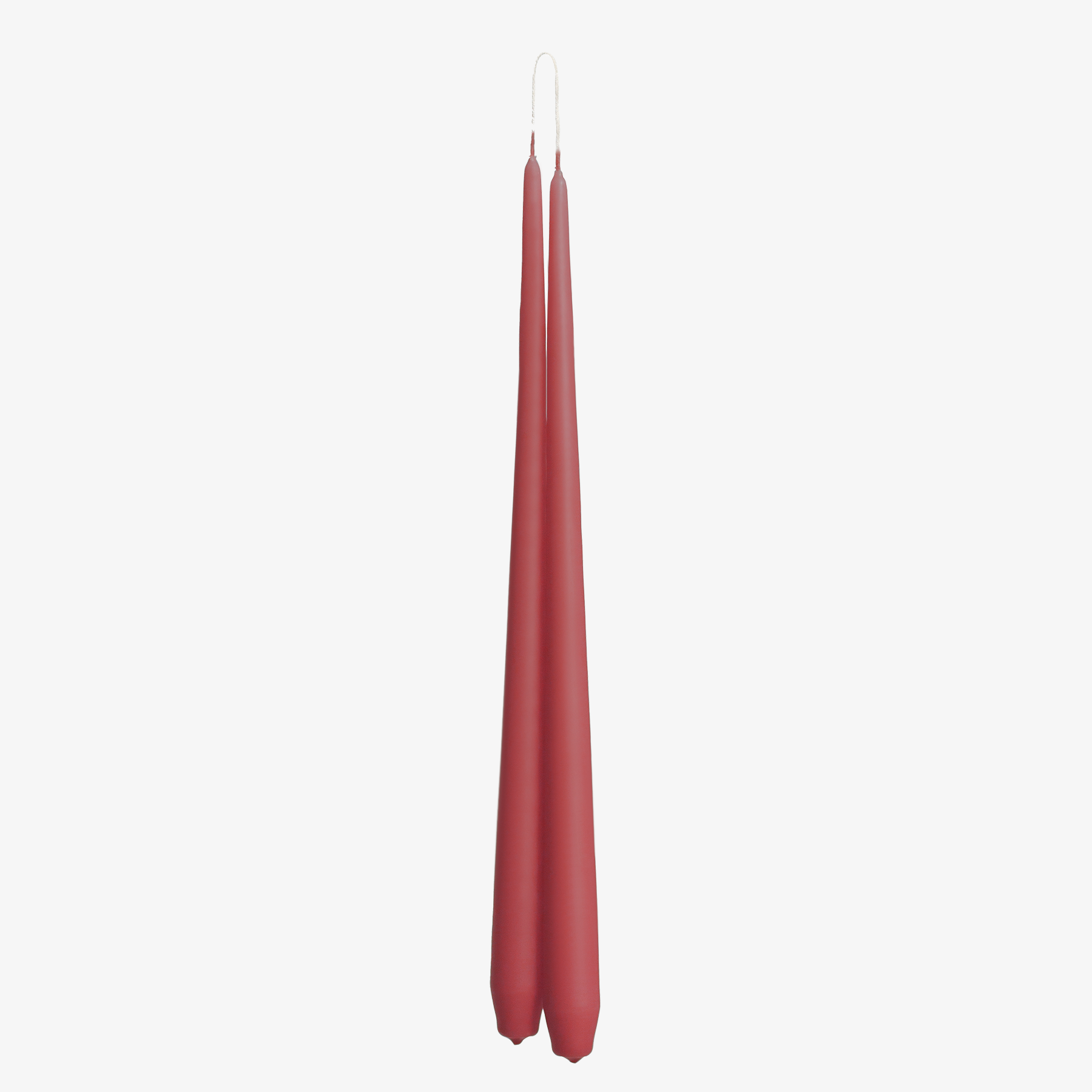 Two pink red candles on a white background