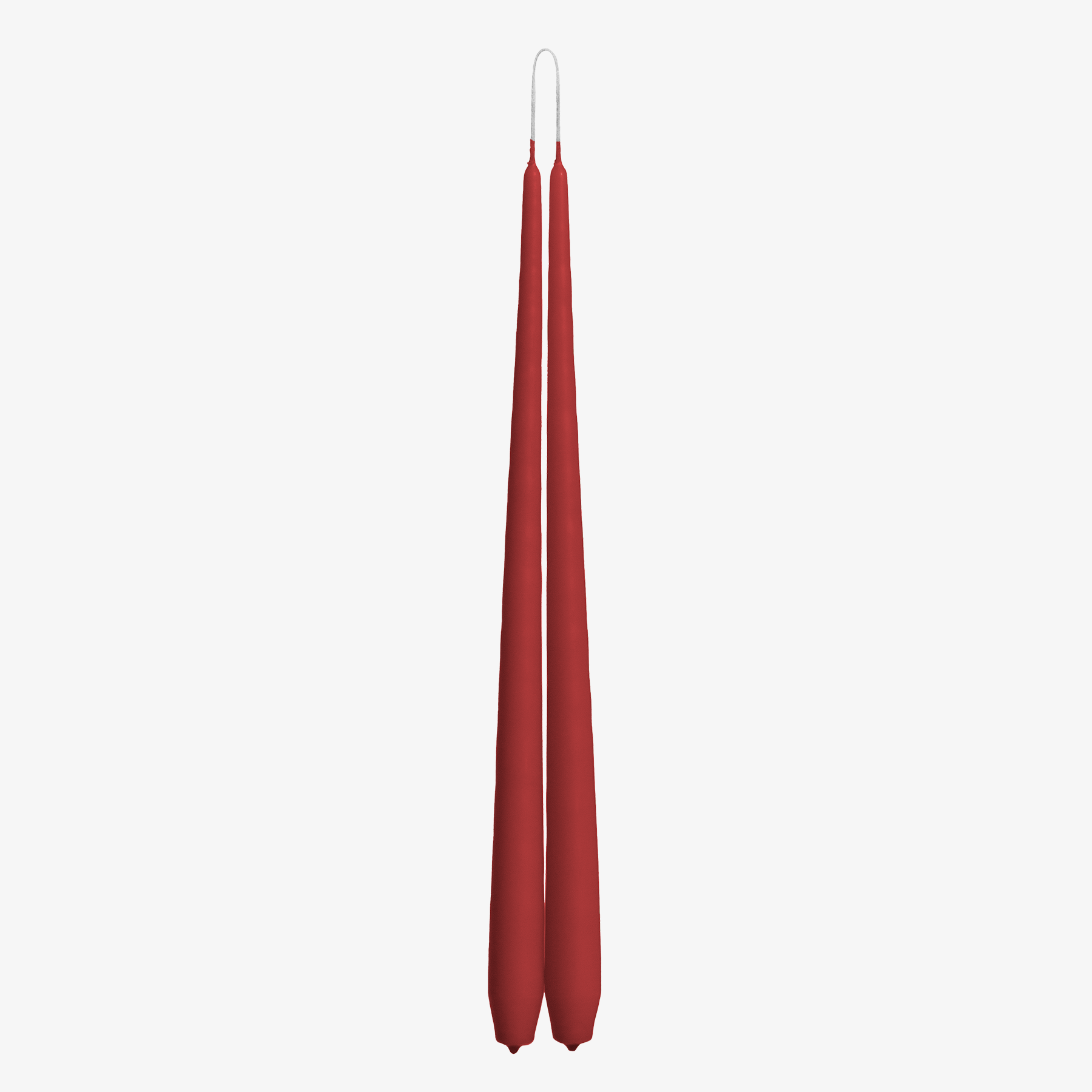 Two red candles on a white background
