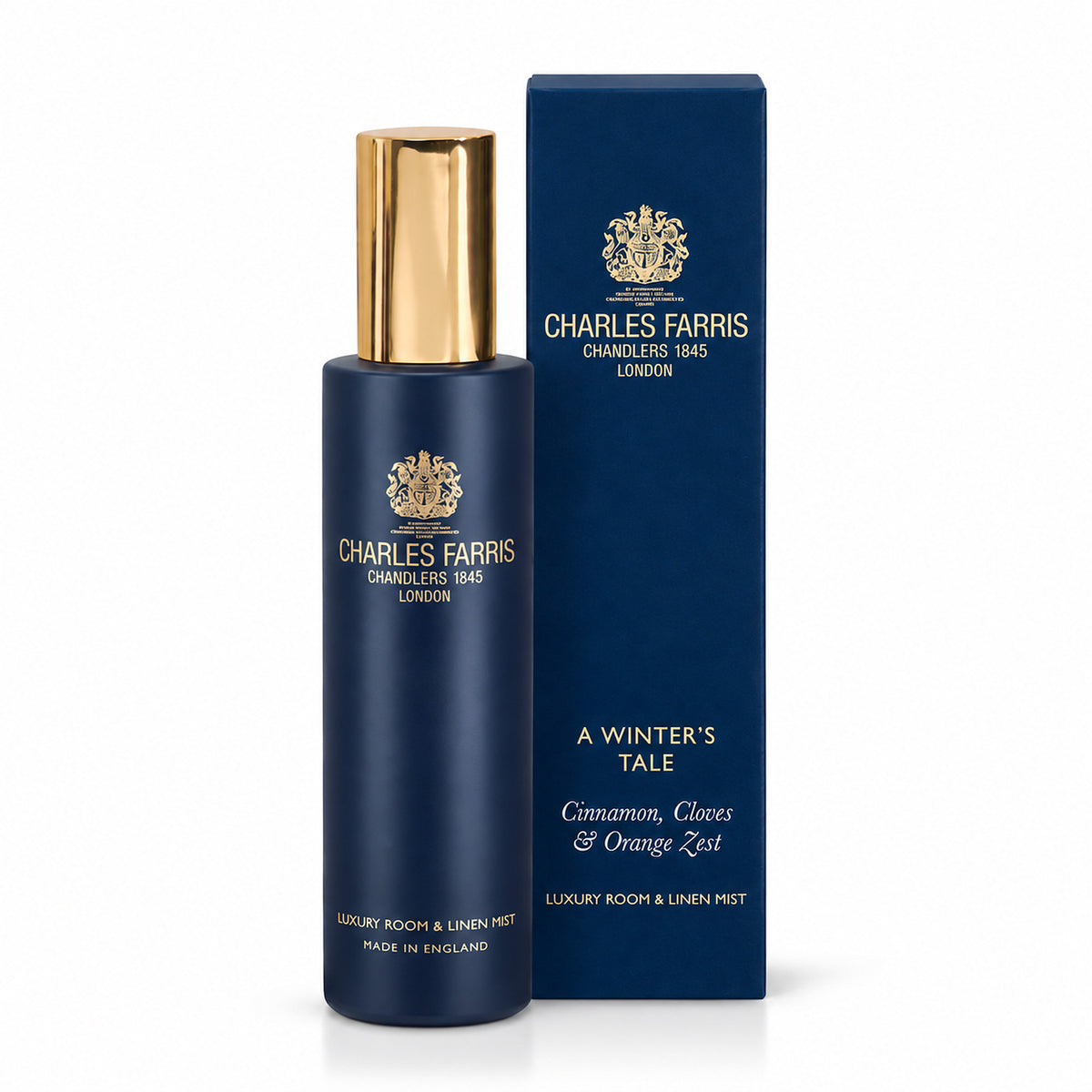 Charles Farris Winter's tale orange & cinnamon amber room mist scented home spray next to it's blue packaging 