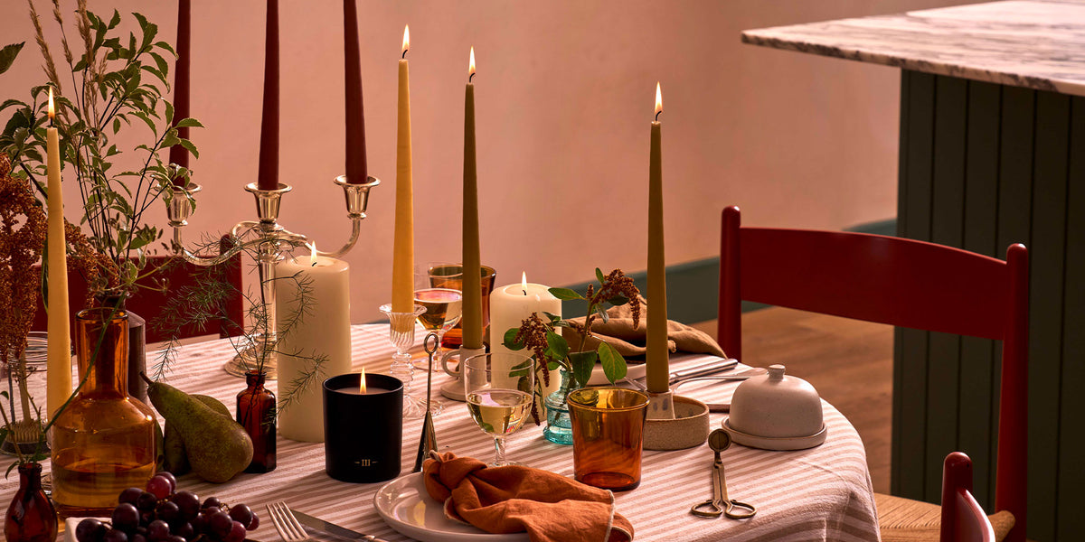 Charles Farris autumn dining table with burgundy, olive and mustard tapered candles in silver candlesticks