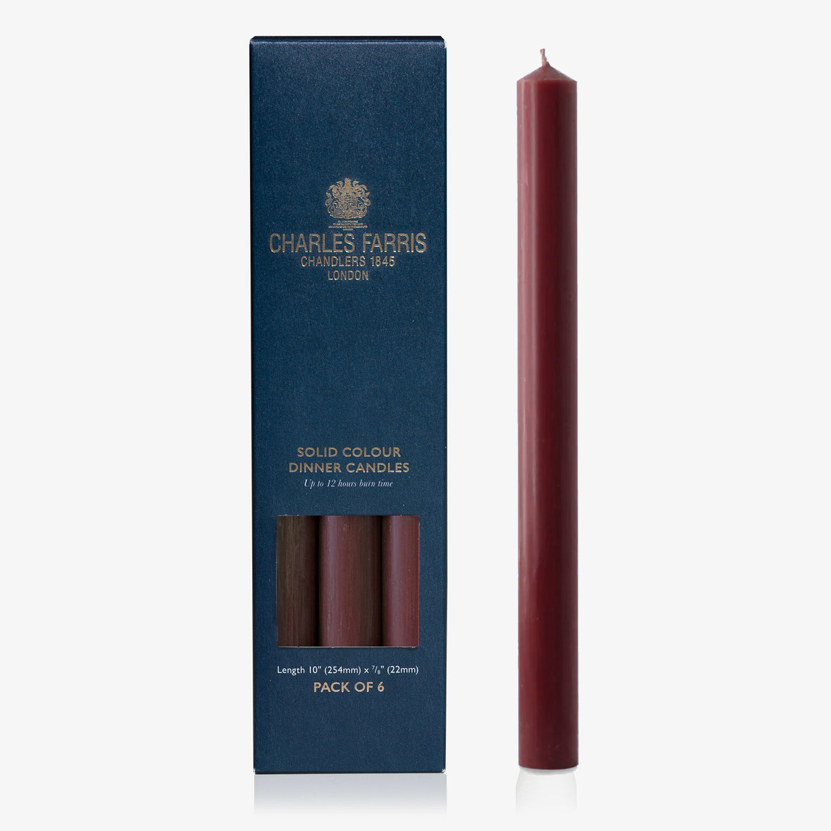 Charles Farris burgundy dinner candle beside its navy box, pack of 6, up to 12 hour burn, made in England