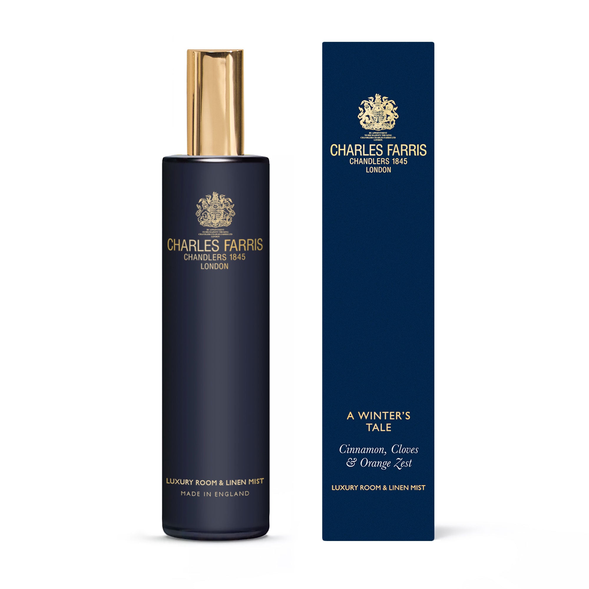 Charles Farris Winter's tale orange & cinnamon amber room mist scented home spray next to it's blue packaging 