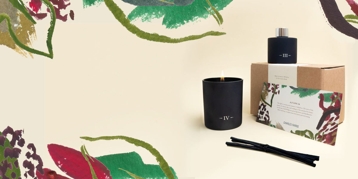 A Candlemaker's Year autumn box with the Redolent Fig candle and Rubus reed diffuser, framed by painted hedgerow leaves and berries